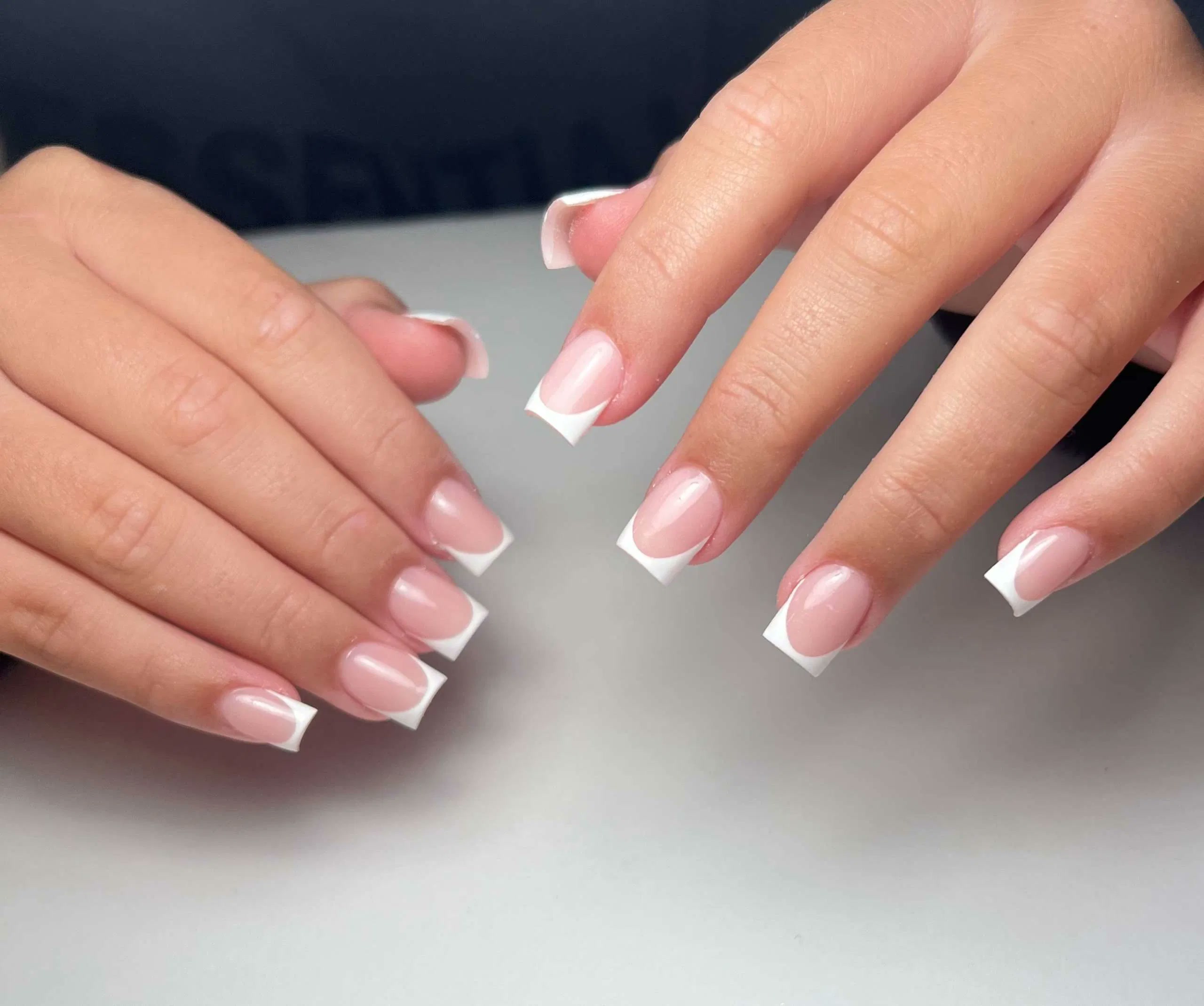 Glossy square French manicure with crisp white tips at Aurevia Nails